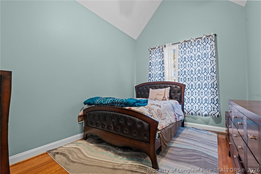 55 London Way Spring Lake, NC 28390 - Photo 12 of 43 a bedroom with a bed and wooden floor