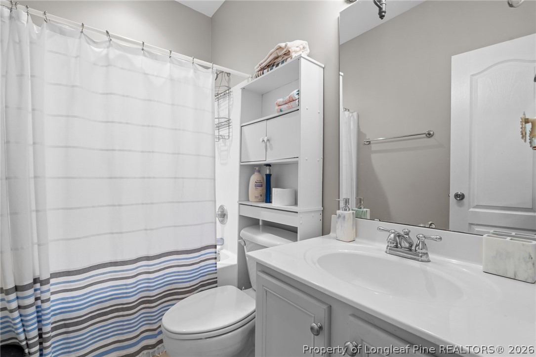 55 London Way Spring Lake, NC 28390 - Photo 13 of 43 a bathroom with a sink toilet vanity and shower