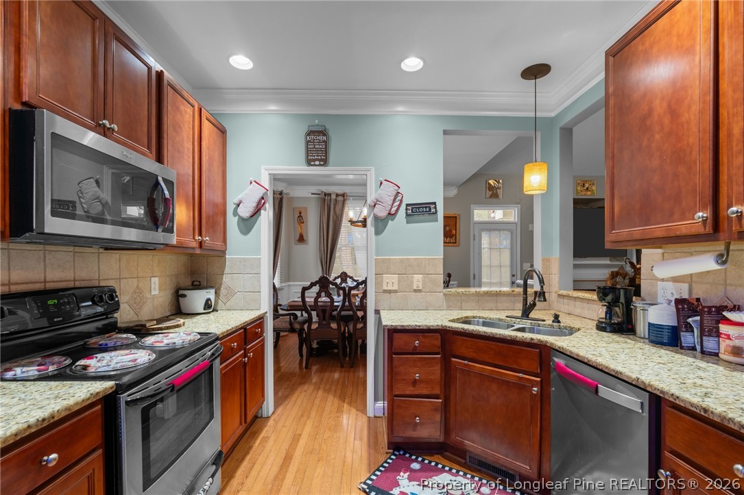 55 London Way Spring Lake, NC 28390 - Photo 21 of 43 a kitchen with stainless steel appliances granite countertop a sink stove and cabinets