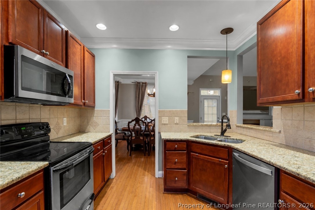 55 London Way Spring Lake, NC 28390 - Photo 22 of 43 a kitchen with stainless steel appliances granite countertop a sink stove and refrigerator