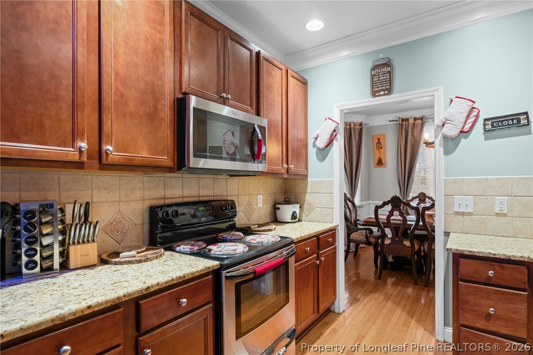 55 London Way Spring Lake, NC 28390 - Photo 23 of 43 a kitchen with stainless steel appliances granite countertop a stove and cabinets