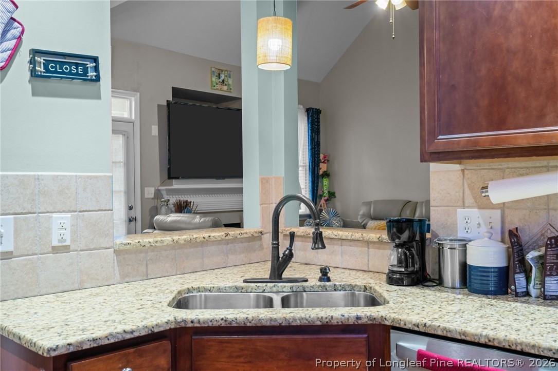 55 London Way Spring Lake, NC 28390 - Photo 24 of 43 a kitchen with kitchen island granite countertop a sink stainless steel appliances and cabinets