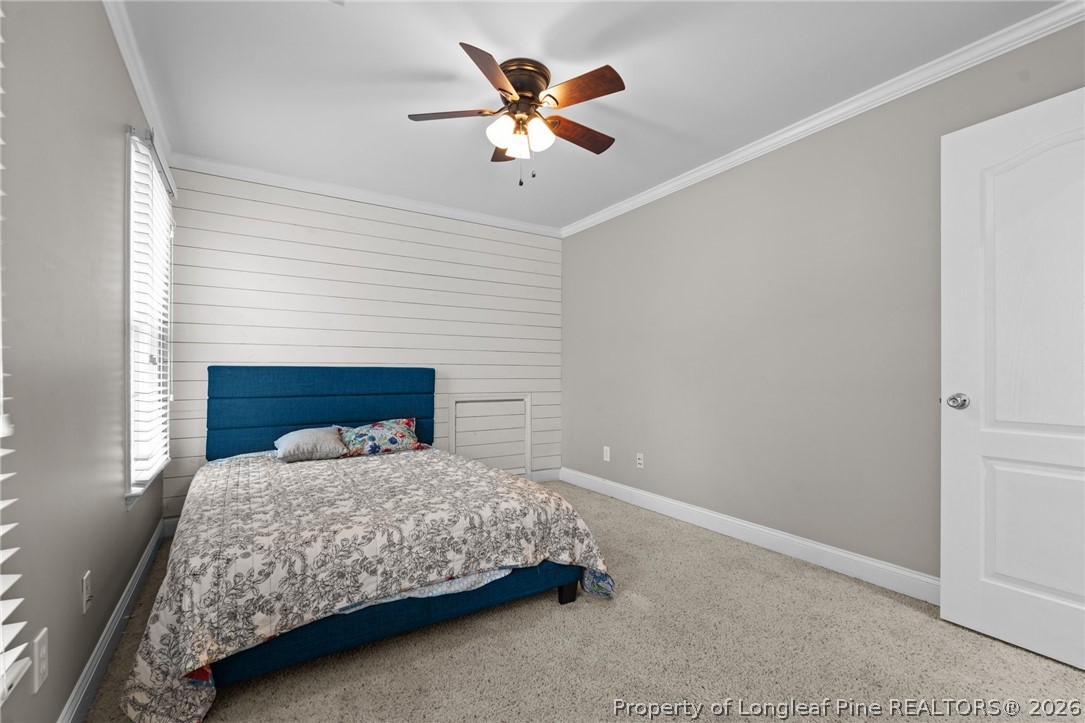55 London Way Spring Lake, NC 28390 - Photo 30 of 43 a bedroom with a bed and a ceiling fan