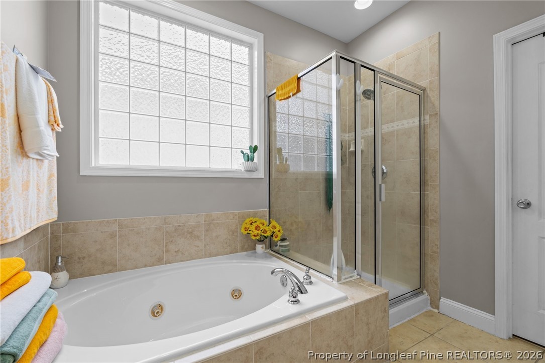 55 London Way Spring Lake, NC 28390 - Photo 9 of 43 a bathroom with a tub and a shower