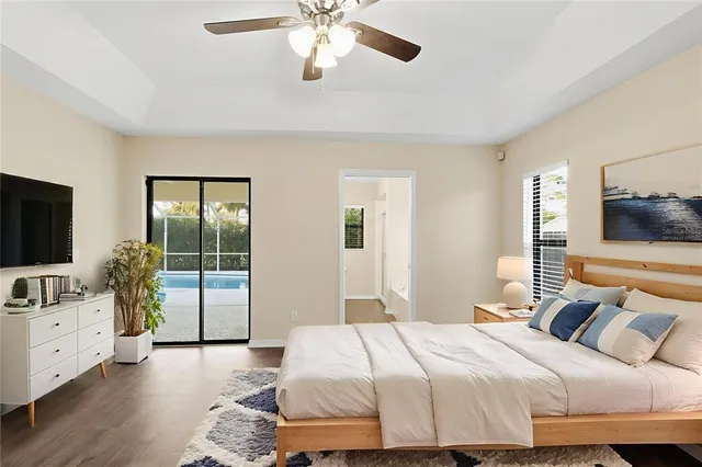 a bedroom with a large bed and a flat tv screen