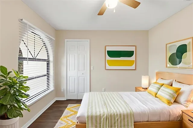 a bedroom with a bed and a painting on the wall