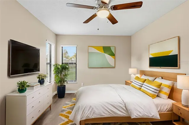 a bedroom with a bed and a flat screen tv