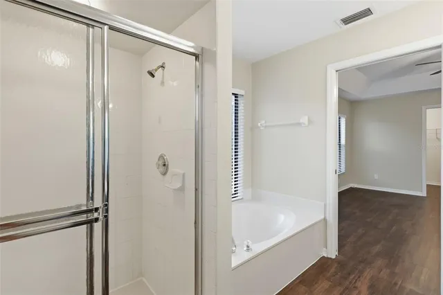 a bathroom with a tub shower and a sink