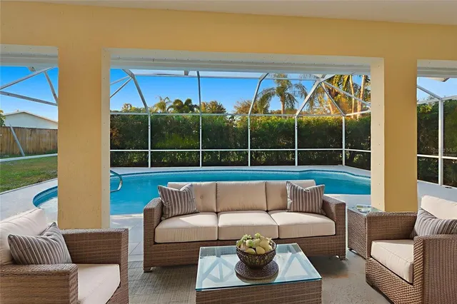 a living room with furniture a rug and a large window