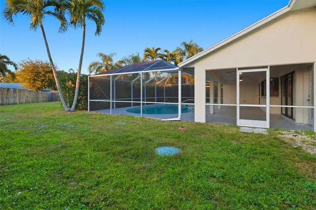 a view of a backyard with a large tree