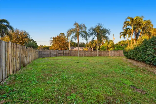 a view of green field with a house in the background