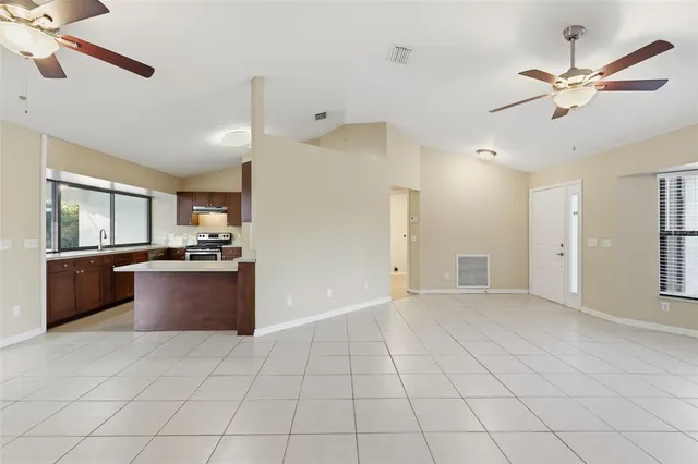 a large kitchen with cabinets and stainless steel appliances