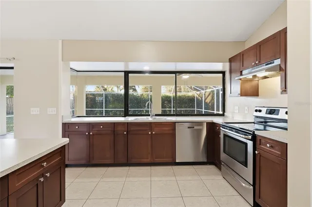 a kitchen with stainless steel appliances granite countertop a stove and a sink