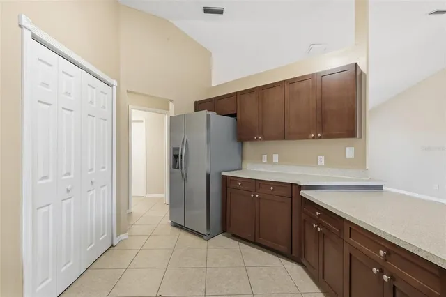 a kitchen with stainless steel appliances granite countertop a refrigerator and a sink