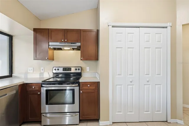 a kitchen with cabinets and stainless steel appliances
