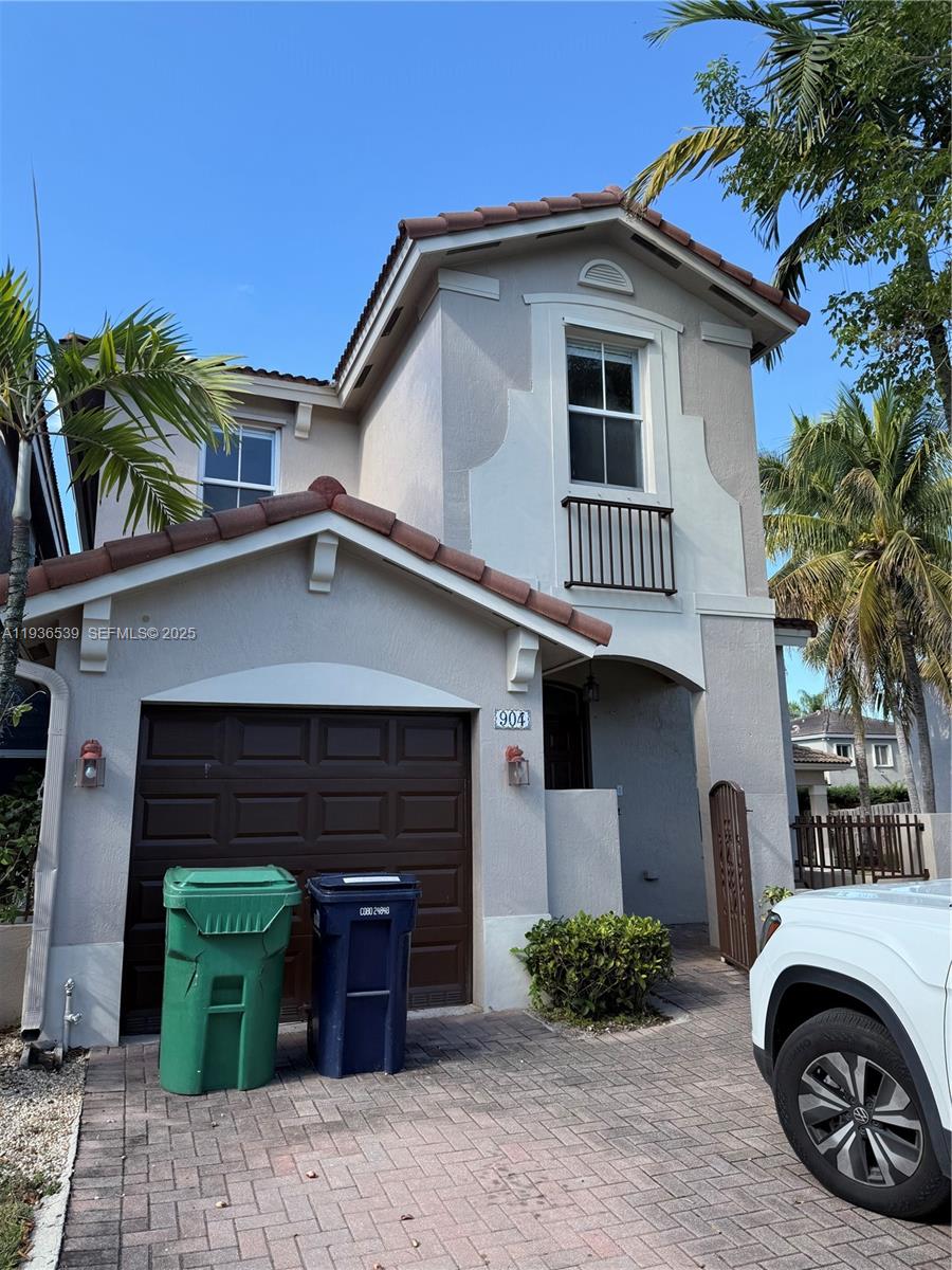 904 Southwest 154th Path Miami, FL 33194 - Photo 2 of 18 a front view of a house with a garden