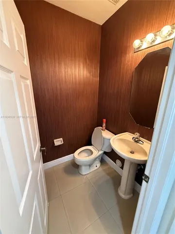 a bathroom with a sink a toilet a mirror and vanity