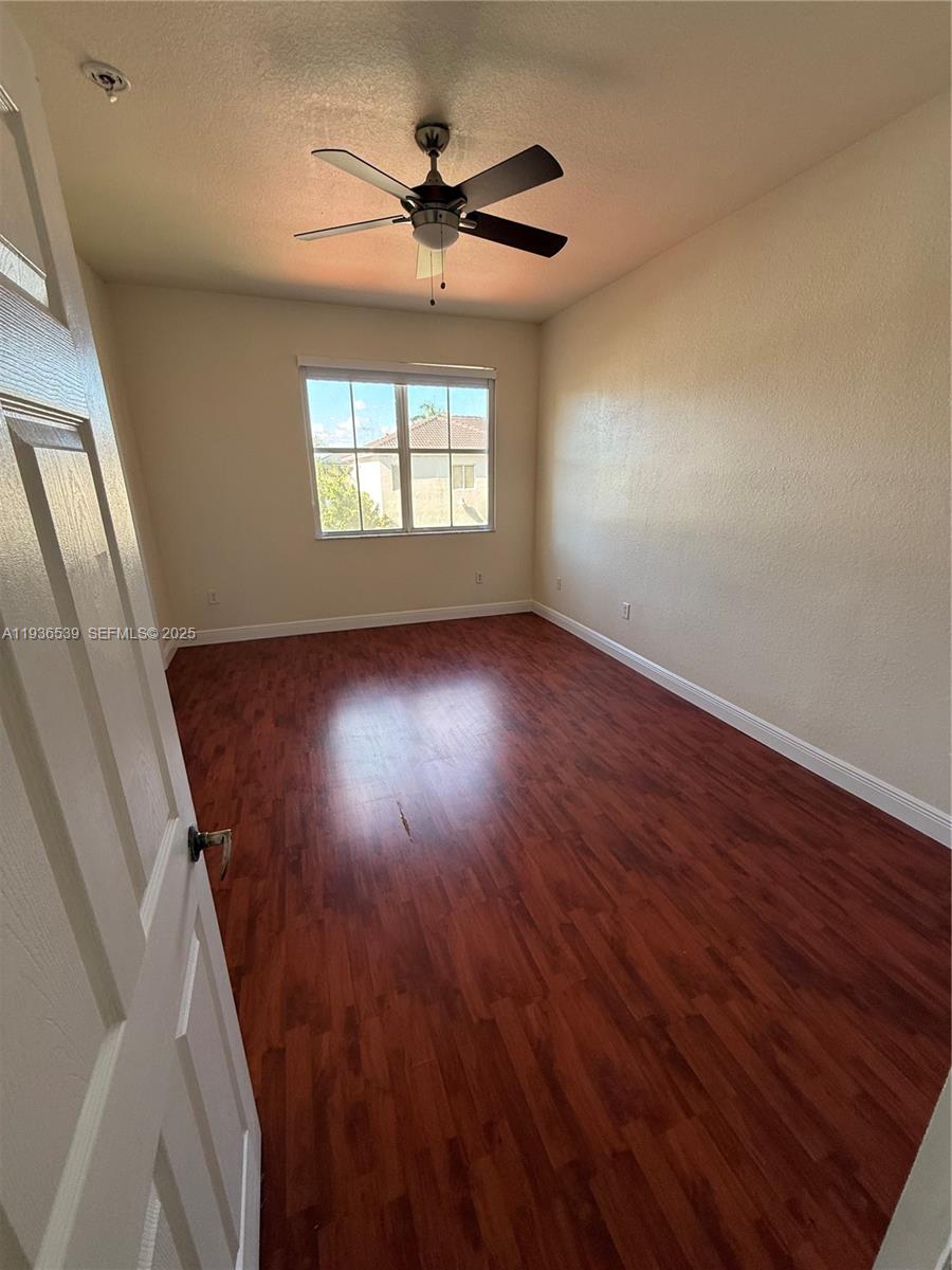 904 Southwest 154th Path Miami, FL 33194 - Photo 9 of 18 wooden floor in an empty room with a window