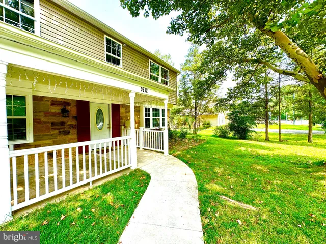 a view of a house with a yard and deck