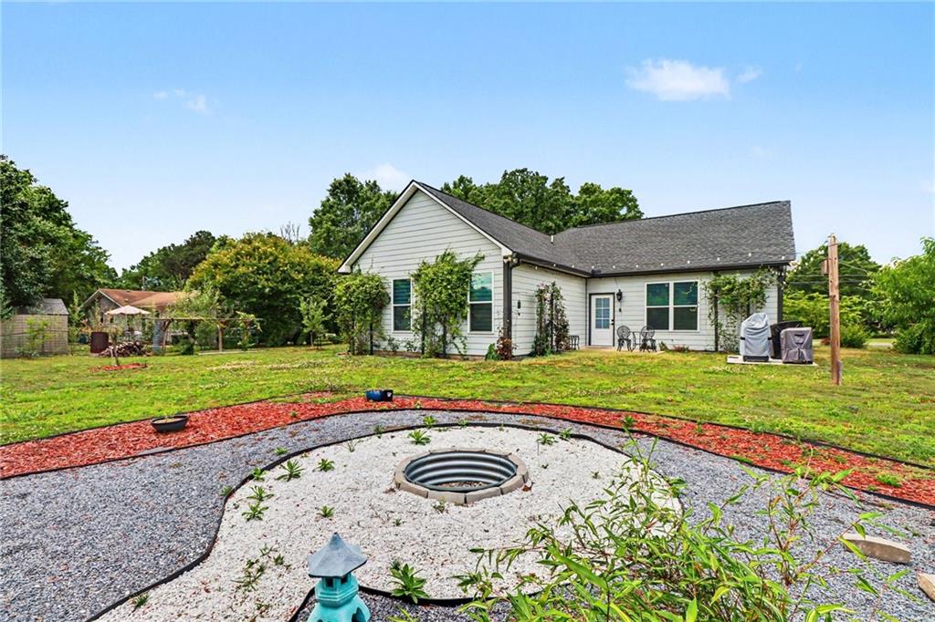 134 North Avery Road Northwest Rome, GA 30165 - Photo 7 of 10 a view of a house with a big yard and potted plants