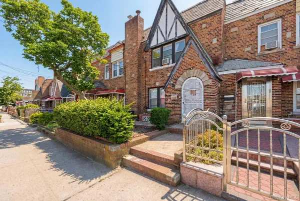 a front view of a house with a garden