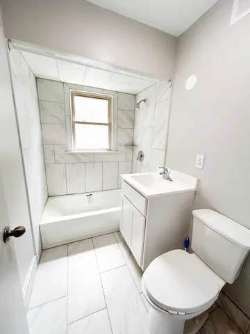 a white toilet sitting next to a bathroom sink