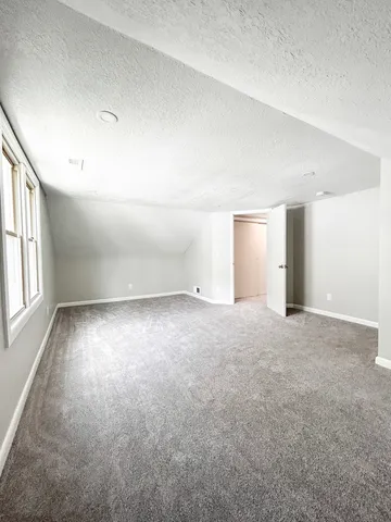 an empty room with a empty space and windows