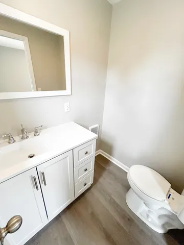 a bathroom with a sink a toilet and mirror