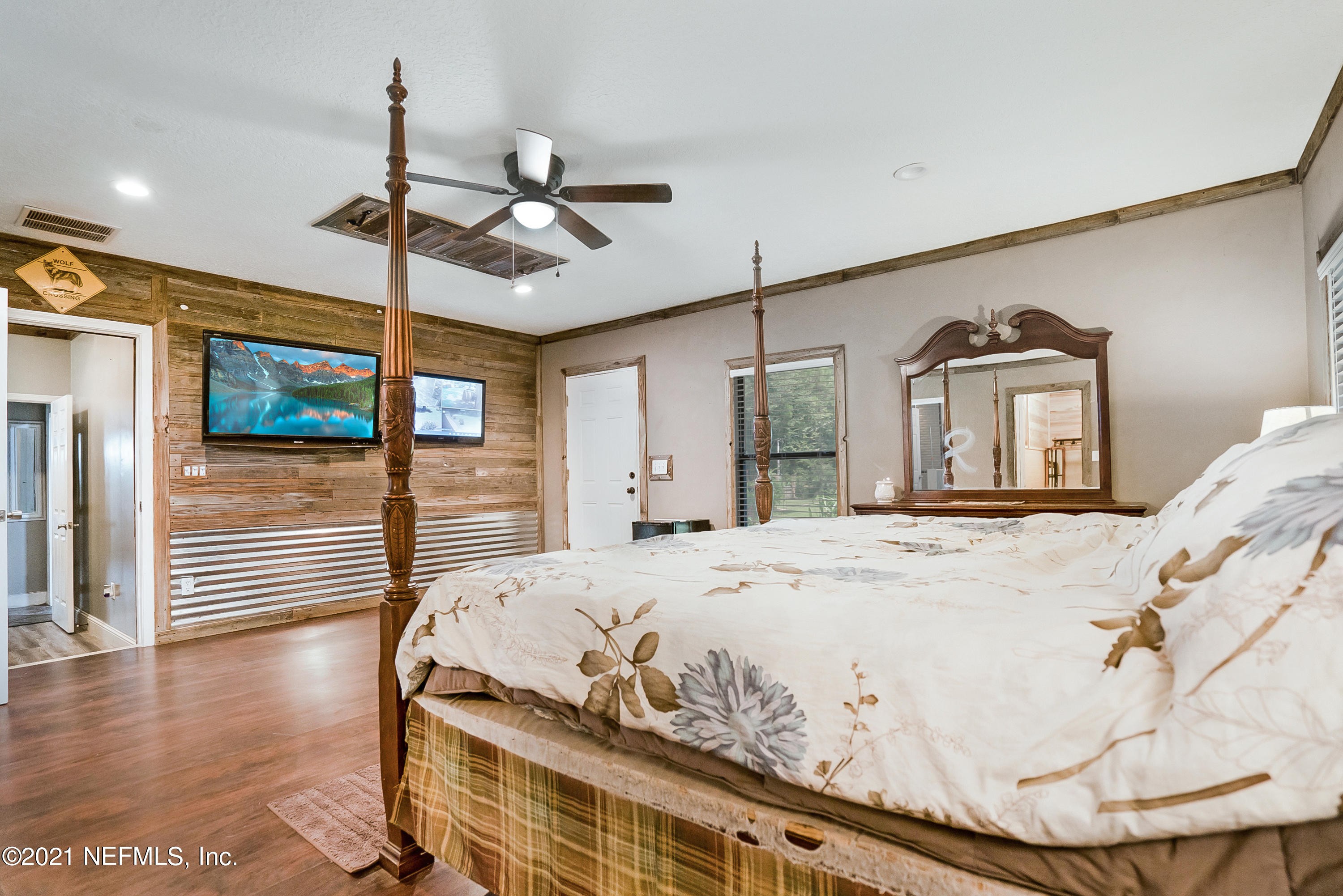 444 George Mosley Road Jacksonville, FL 32234 - Photo 18 of 58 a bed room with a bed and a chandelier