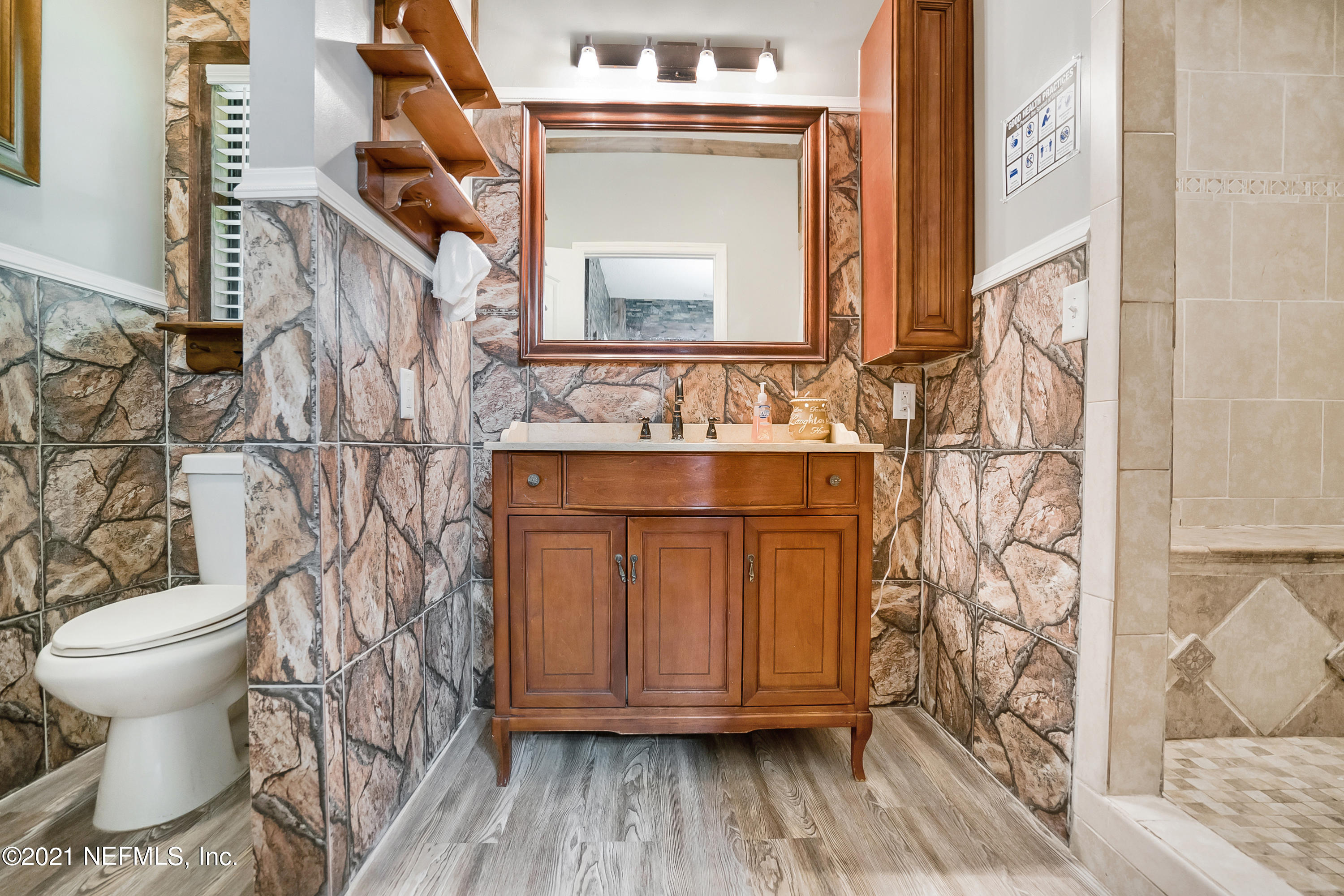 444 George Mosley Road Jacksonville, FL 32234 - Photo 26 of 58 a bathroom with a granite countertop toilet and a sink