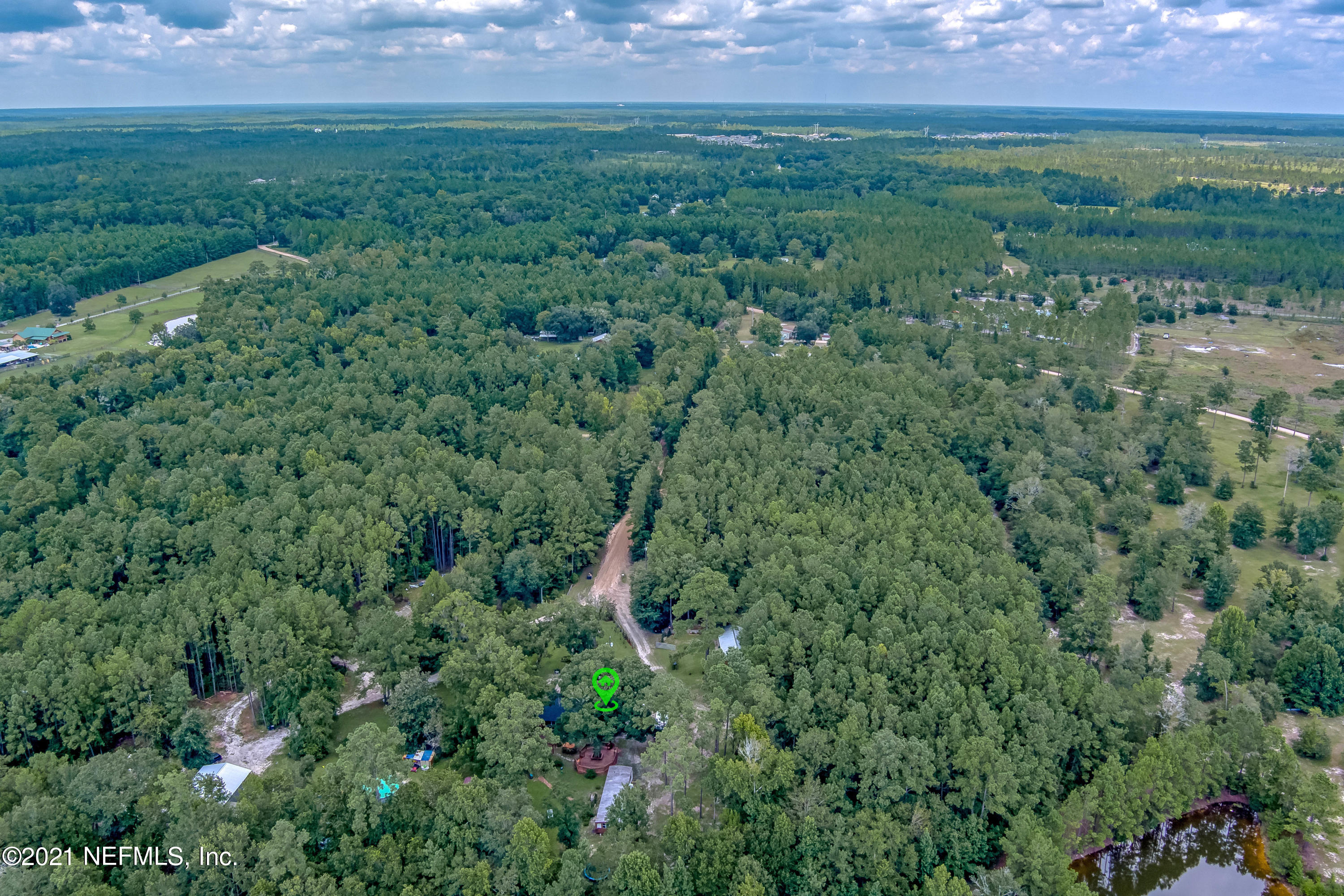 444 George Mosley Road Jacksonville, FL 32234 - Photo 54 of 58 a view of a field of grass and trees