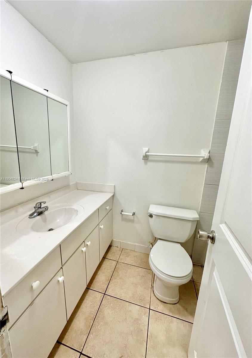 8600 Southwest 109th Avenue, Unit 4211 Miami, FL 33173 - Photo 17 of 25 a bathroom with a sink a toilet and a mirror