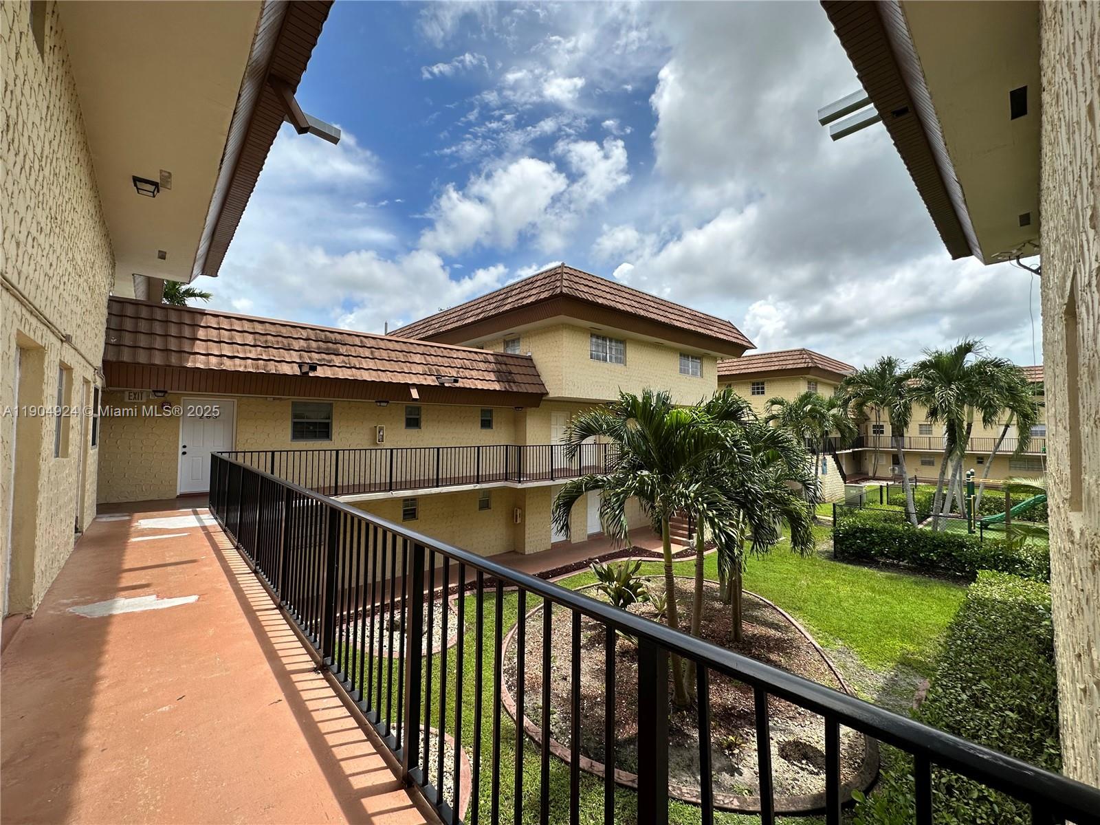 8600 Southwest 109th Avenue, Unit 4211 Miami, FL 33173 - Photo 3 of 25 a view of a house with brick walls and wooden fence