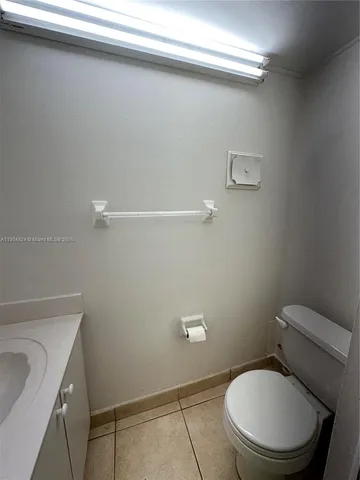 a white toilet sitting next to a bathroom sink