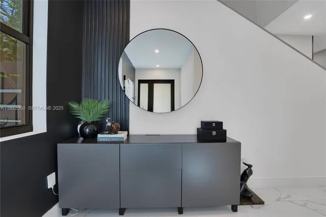 a living room with furniture and a mirror