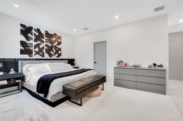 a bedroom with a bed and wall painting