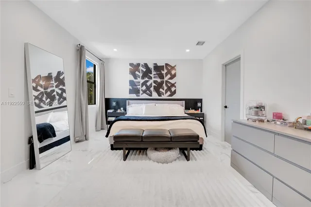 a bedroom with furniture and a chandelier