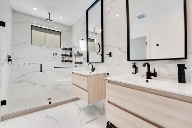 a bathroom with a bathtub sink and mirror