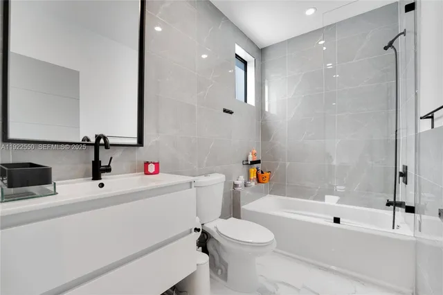 a bathroom with a sink a toilet and a bathtub