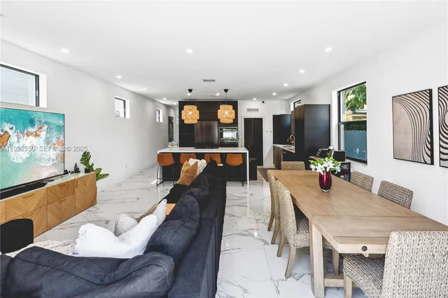 a dining room with furniture and wooden floor