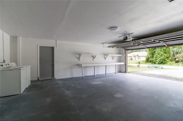 a view of empty room with wooden floor and windows
