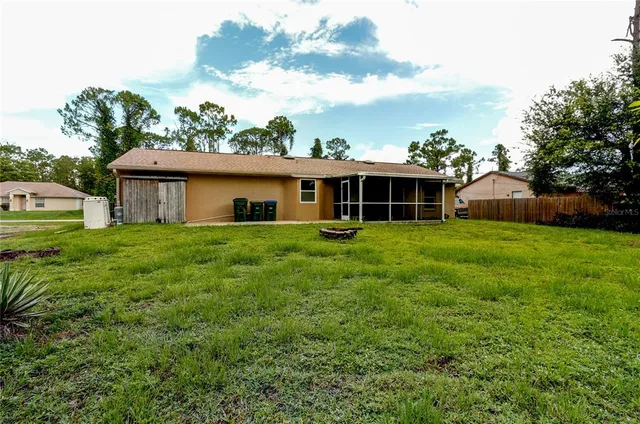 a view of a house with yard and sitting area