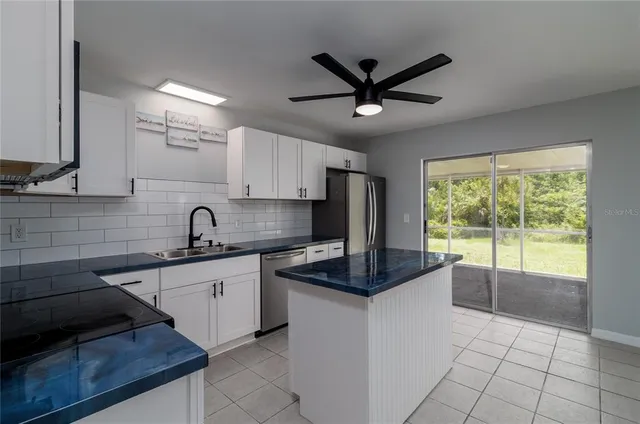 a kitchen with a sink appliances and cabinets