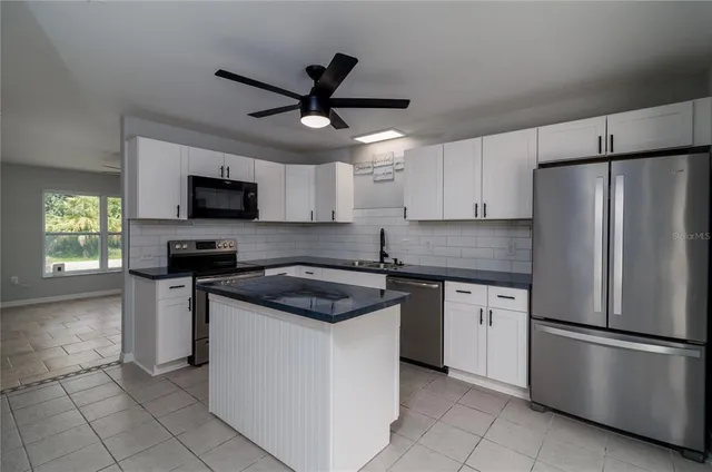 a kitchen with a stainless steel appliances cabinets and a counter top space