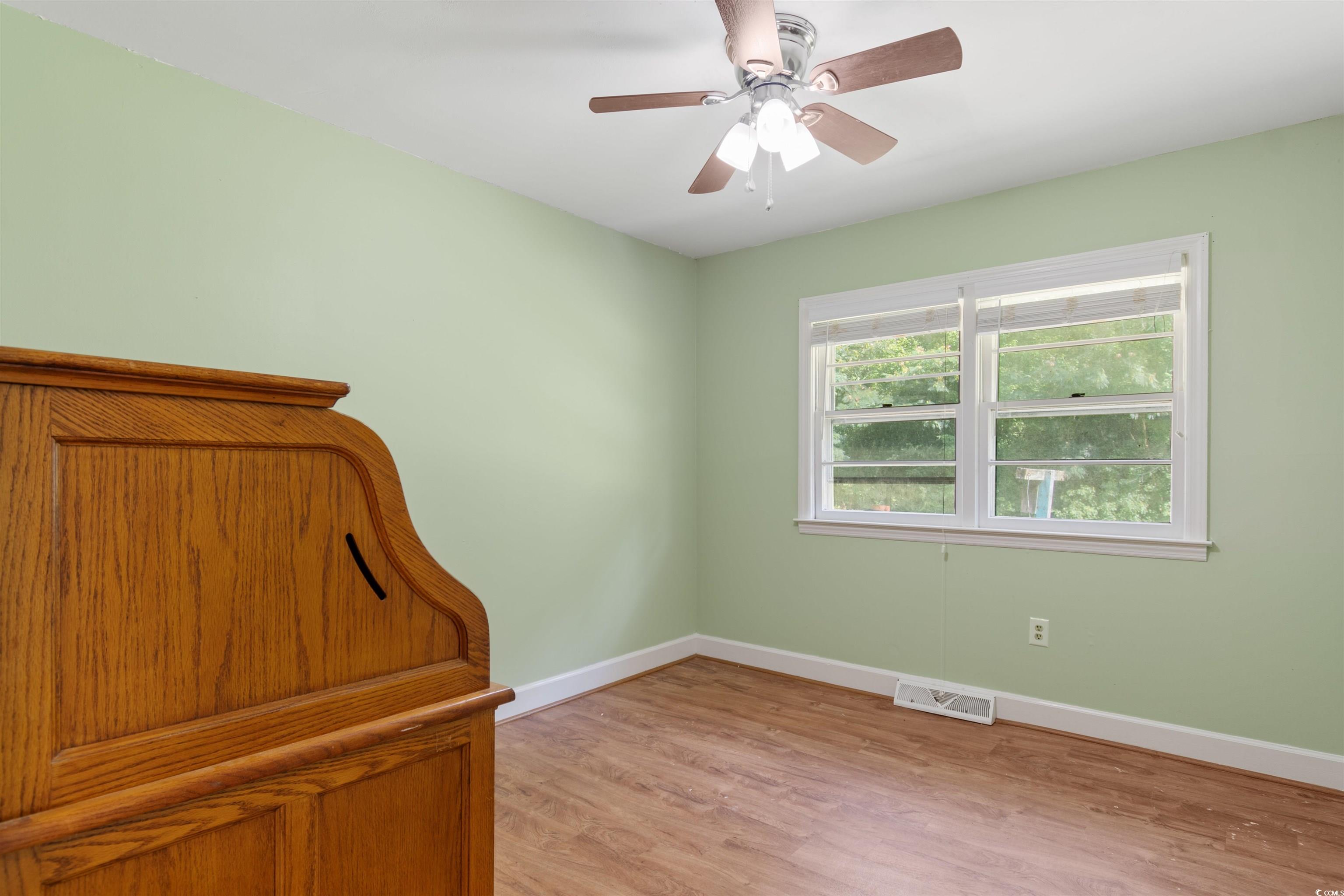 5 County Rd S-45-516 Hemingway, SC 29554 - Photo 20 of 30 Unfurnished bedroom featuring light wood finished floors and a ceiling fan