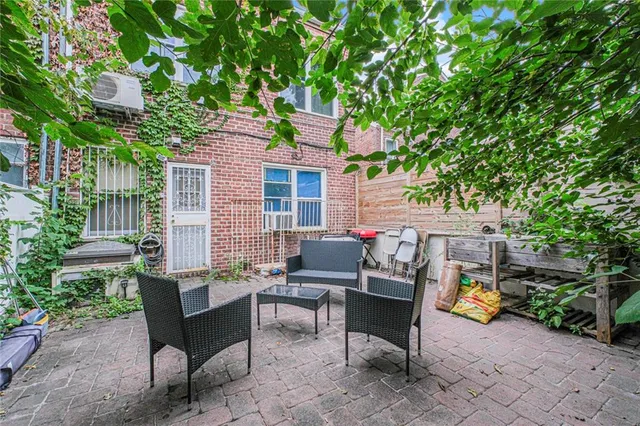 a view of a patio with table and chairs and potted plants