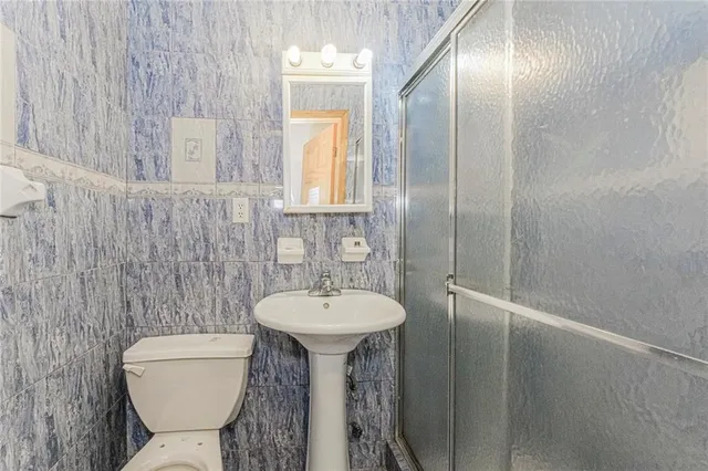 a bathroom with a sink a toilet and mirror