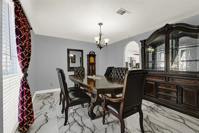 a dining room with furniture and window