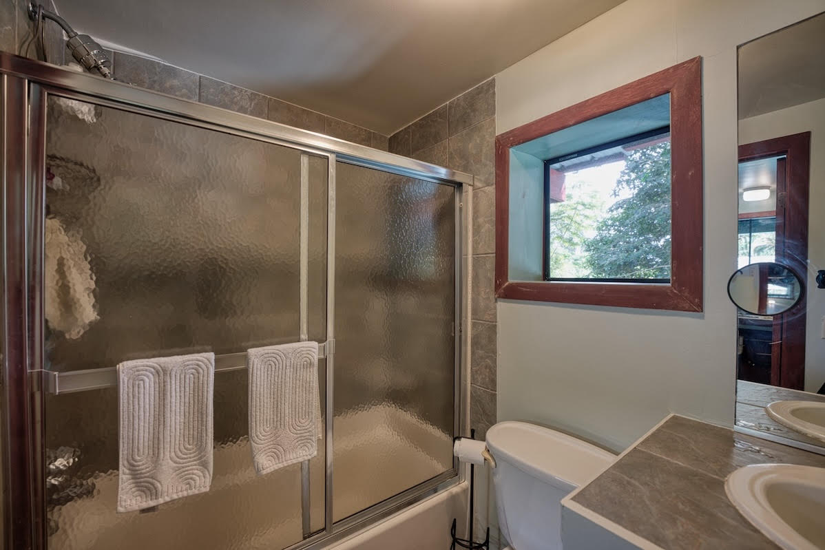 17-406 13 Mile Road Kurtistown, HI 96749 - Photo 26 of 29 a bathroom with a granite countertop sink a toilet and shower