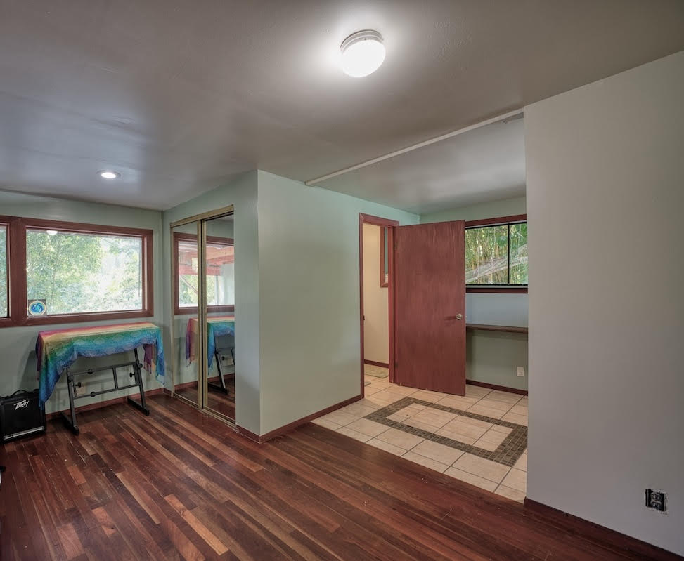 17-406 13 Mile Road Kurtistown, HI 96749 - Photo 27 of 29 wooden floor in an empty room with a window